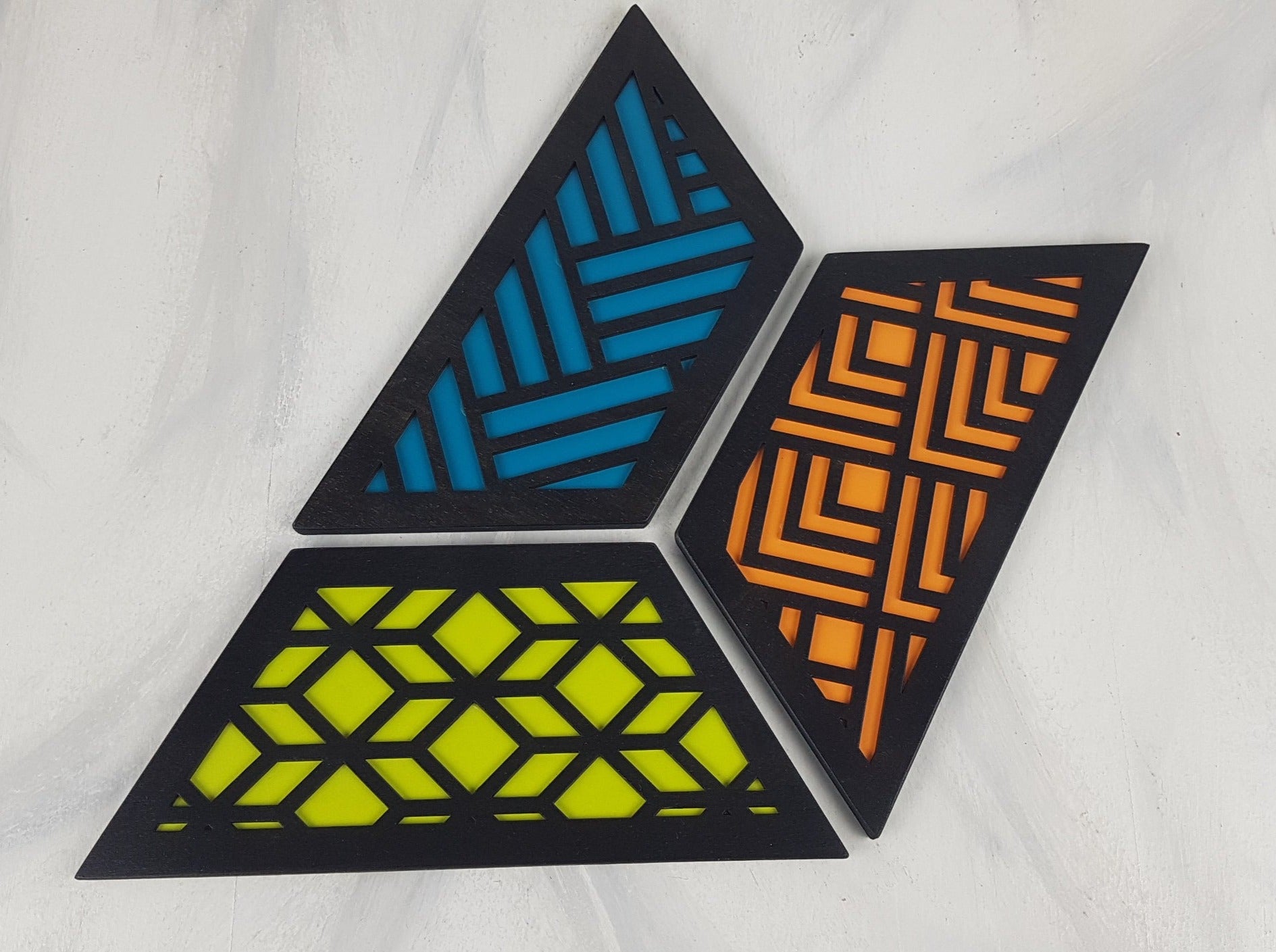 A close-up of one of the hexagonal trivets with a black stain finish. Handmade Heat Resistant Kitchen Accessories