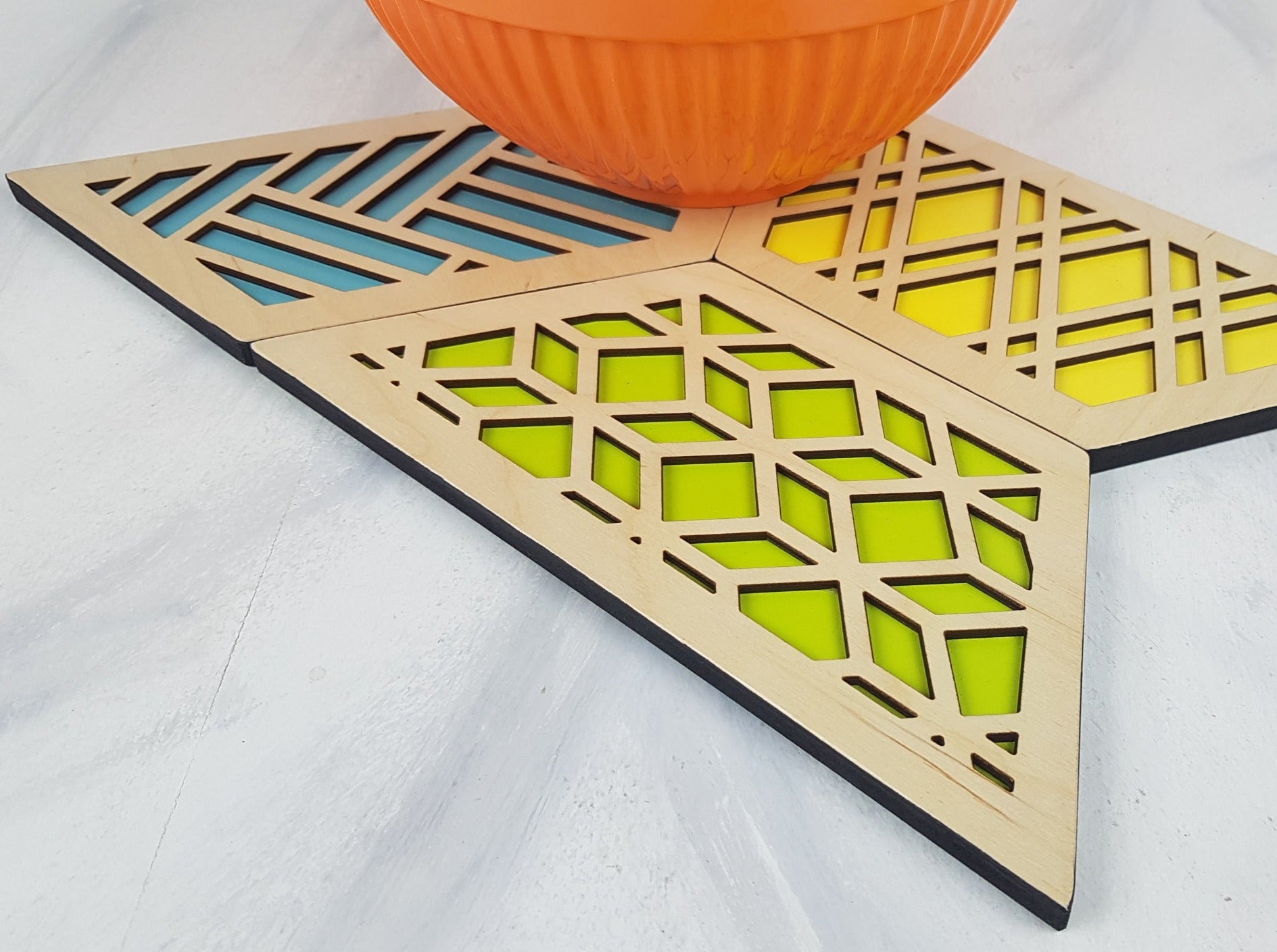 A close-up of one of the hexagonal trivets with a black stain finish. Handmade Heat Resistant Kitchen Accessories