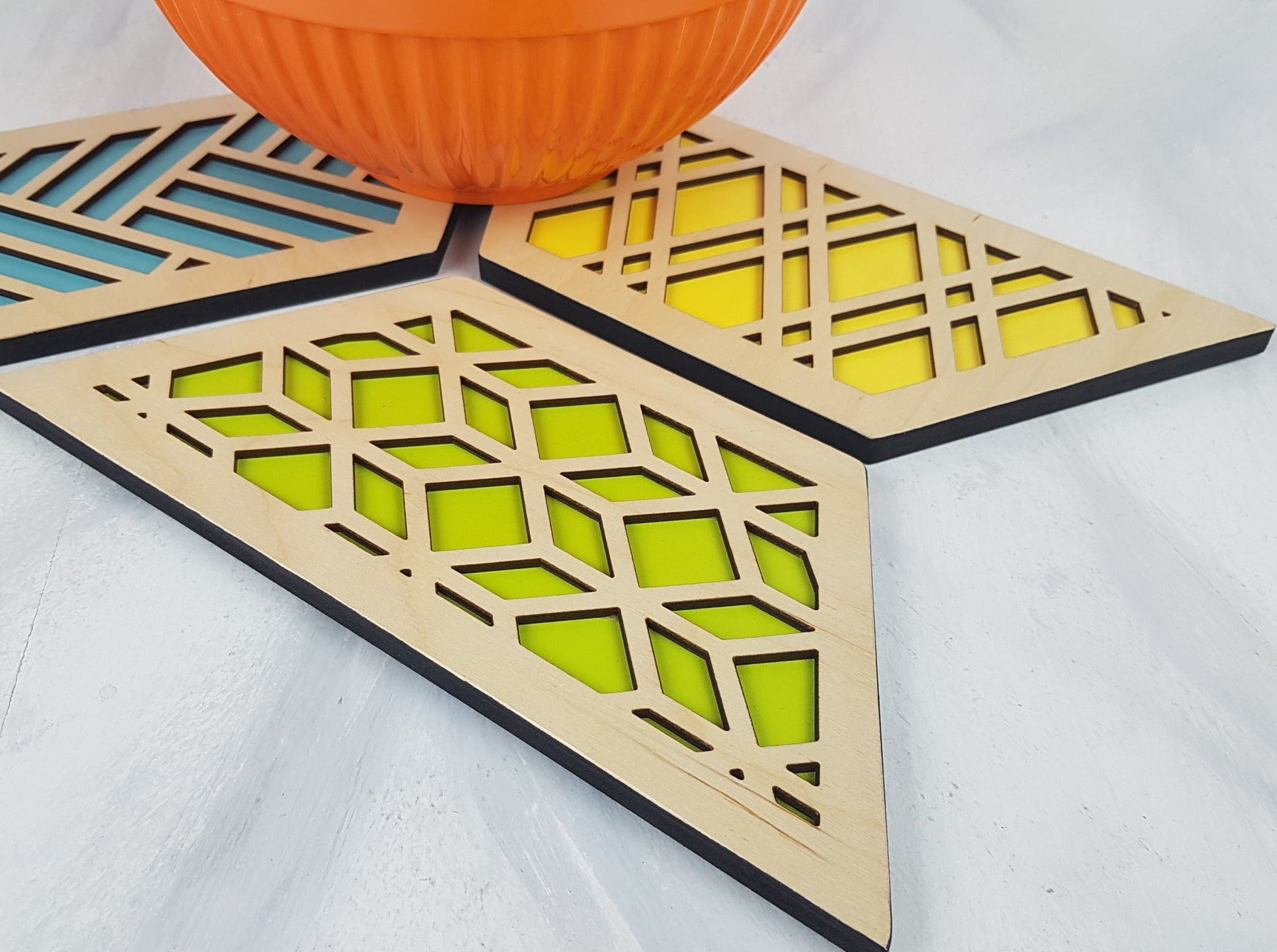 A group shot of the colorful geometric hexagon trivets arranged together.