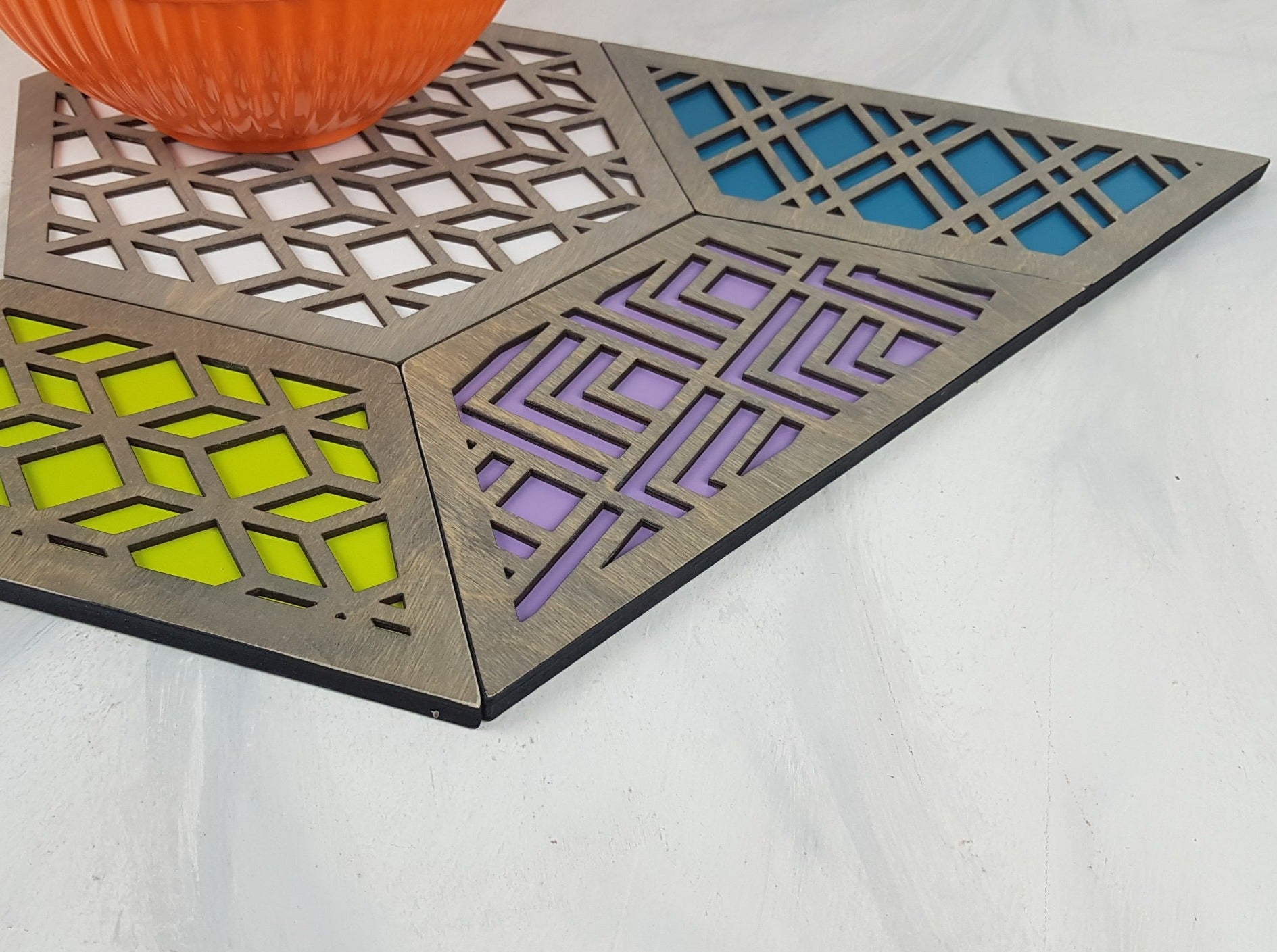 A group shot of the colorful geometric hexagon trivets arranged together.