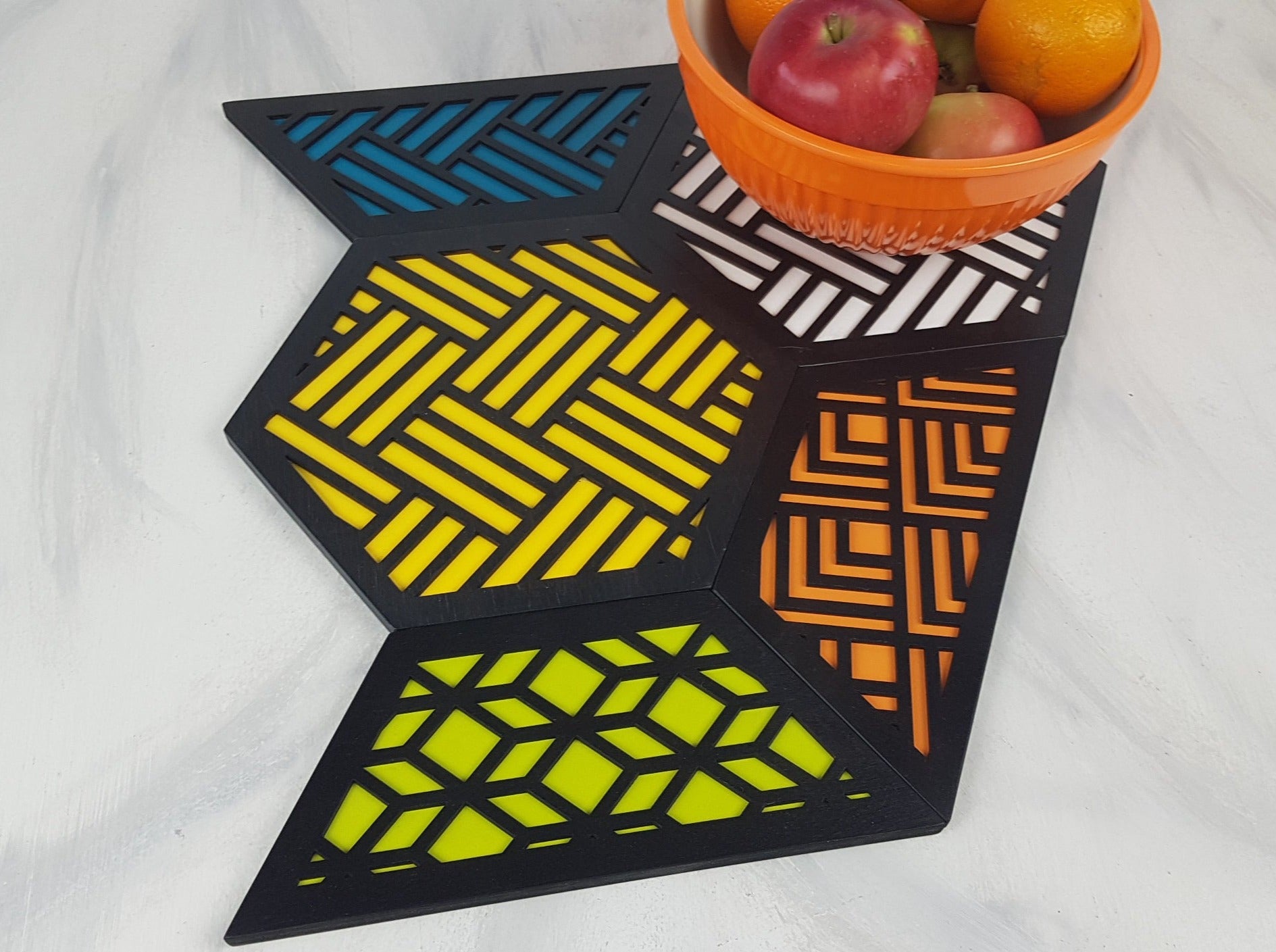 A group shot of the colorful geometric hexagon trivets arranged together.