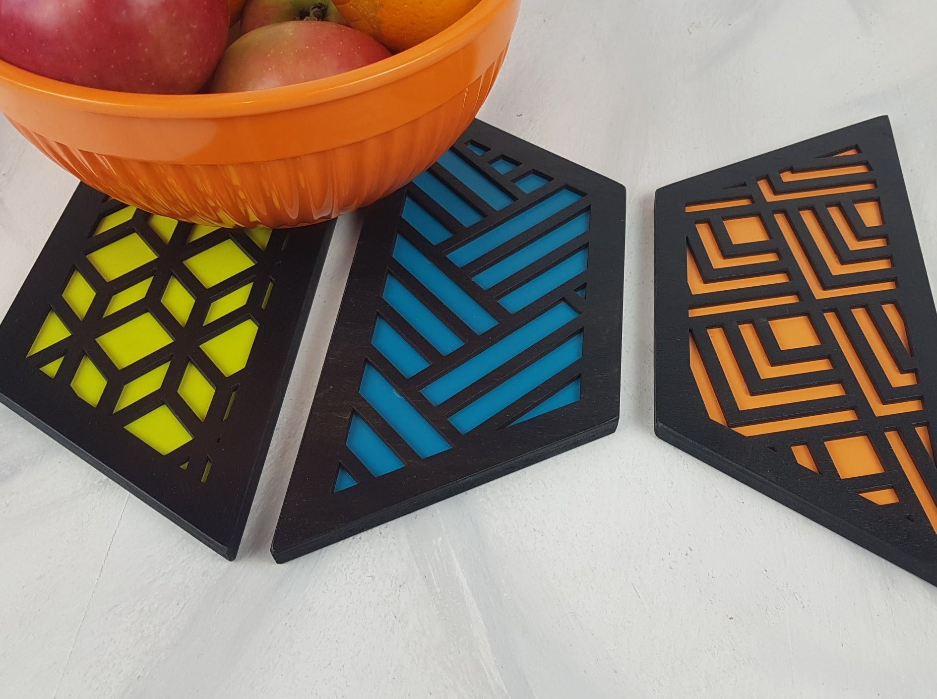 A close-up of one of the hexagonal trivets with a black stain finish. Handmade Heat Resistant Kitchen Accessories