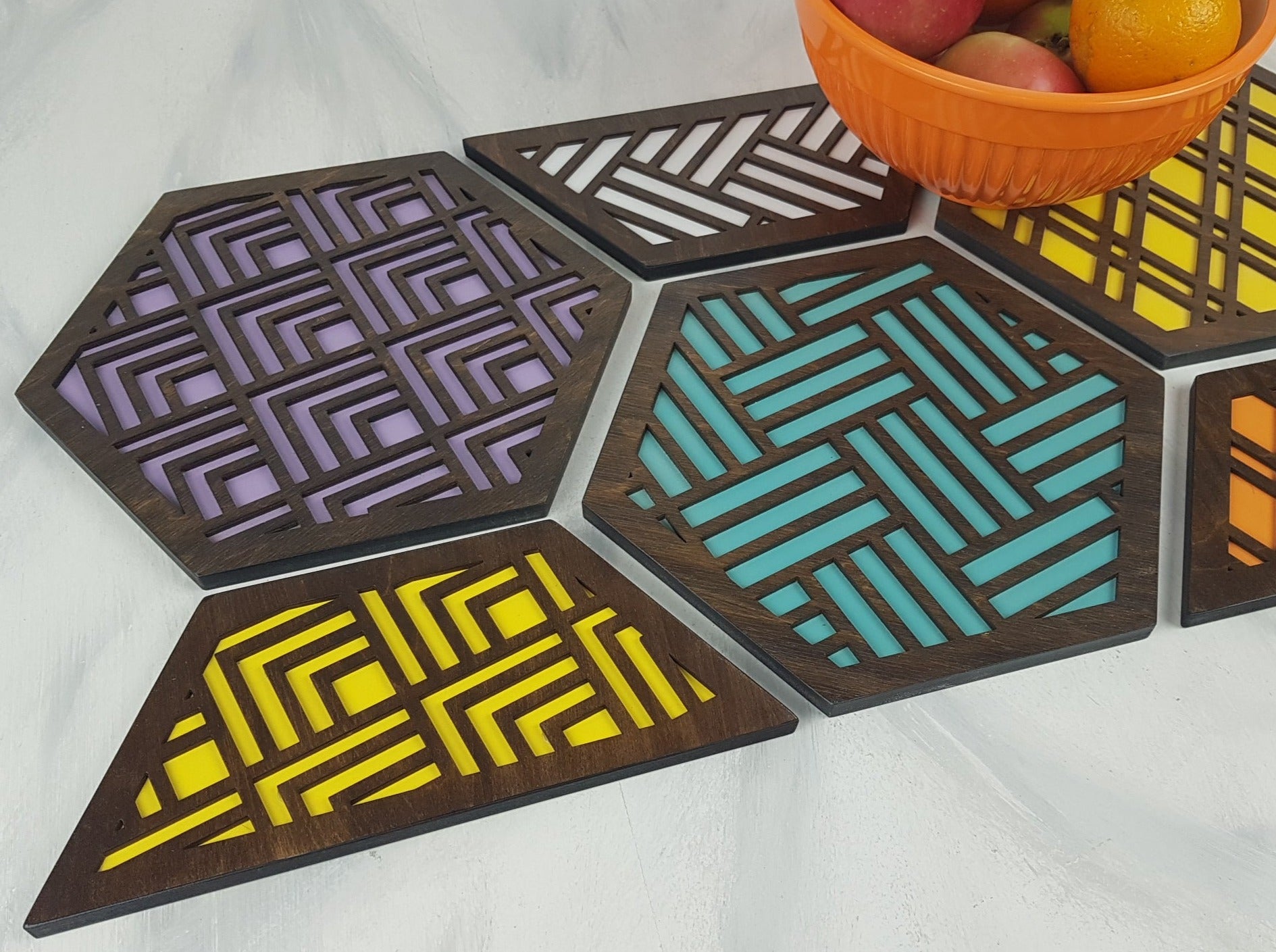 A close-up of one of the hexagonal trivets with a black stain finish. Handmade Heat Resistant Kitchen Accessories