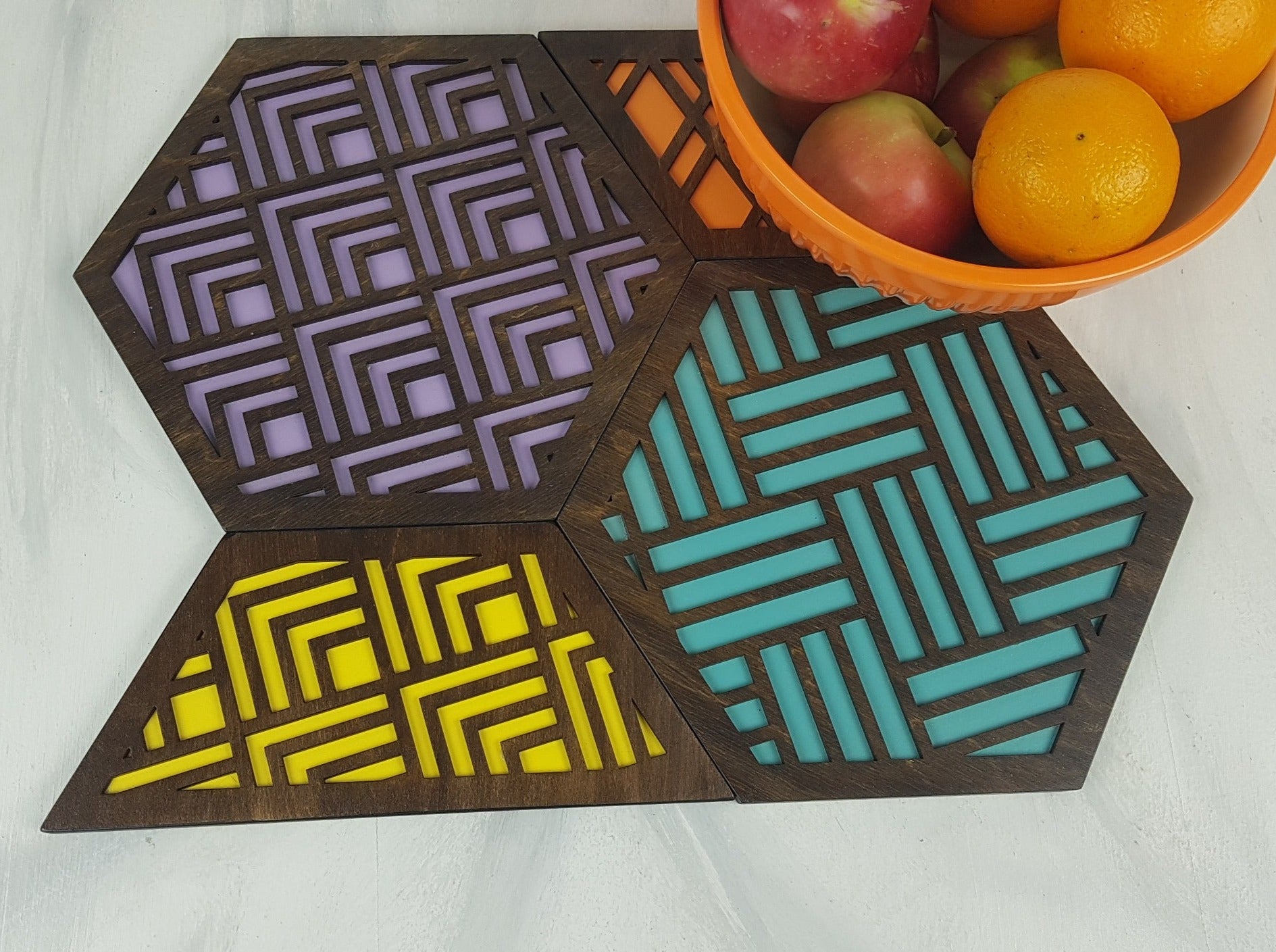 A group shot of the colorful geometric hexagon trivets arranged together.