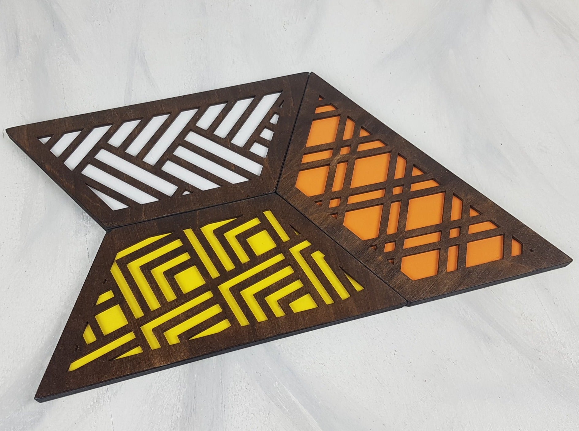 A close-up of one of the hexagonal trivets with a walnut stain finish. Handmade Heat Resistant Kitchen Accessories