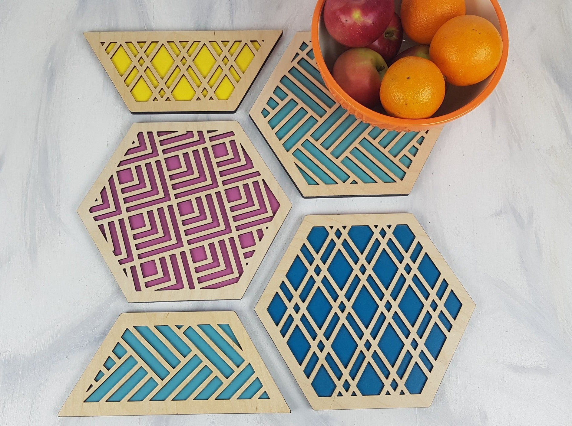 A close-up of one of the hexagonal trivets with a black stain finish. Handmade Heat Resistant Kitchen Accessories