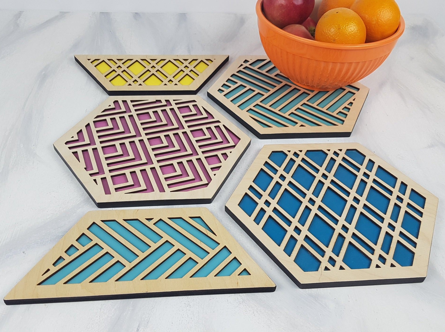 A group shot of the colorful geometric hexagon trivets arranged together.