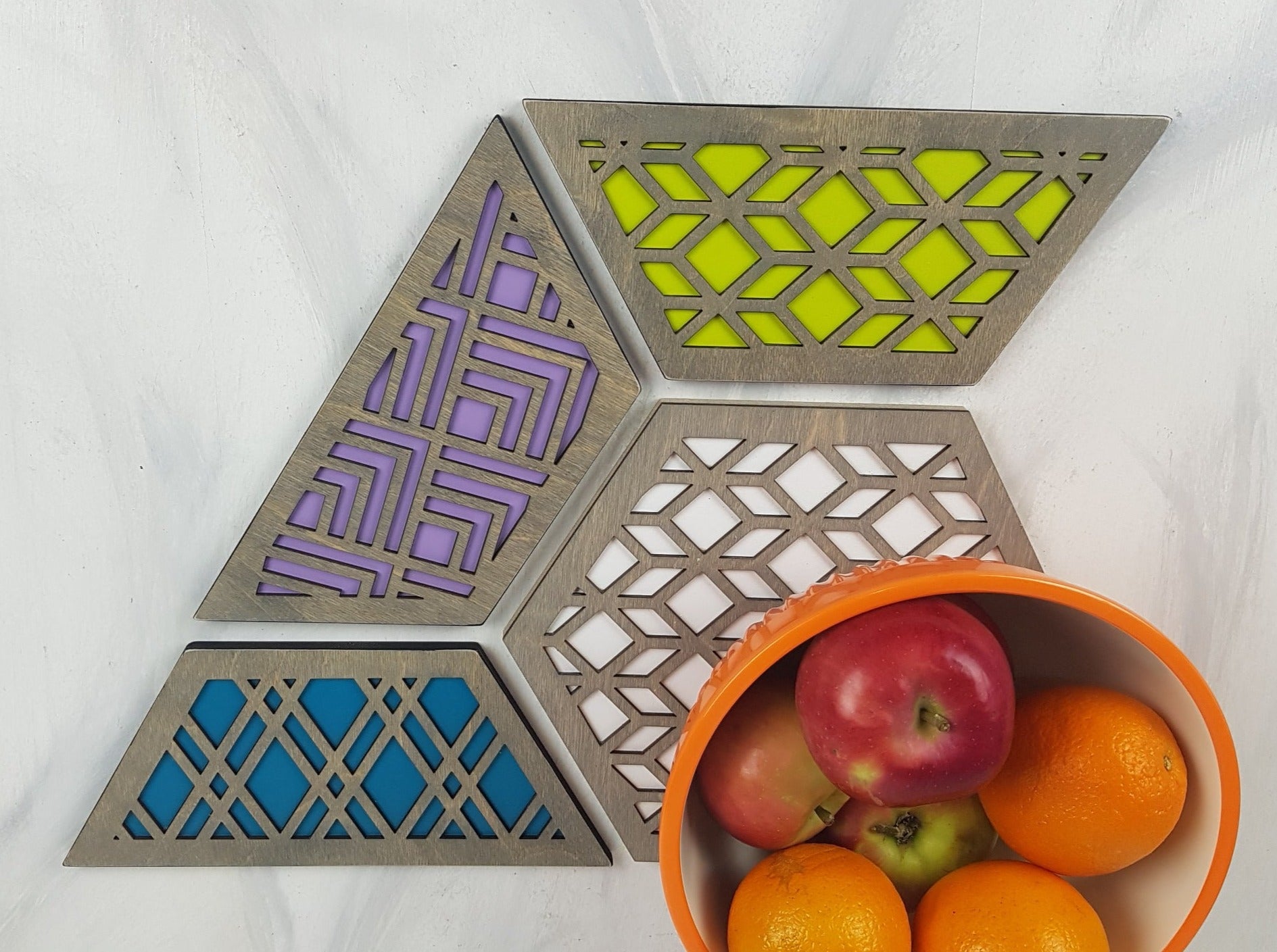 A group shot of the colorful geometric hexagon trivets arranged together.