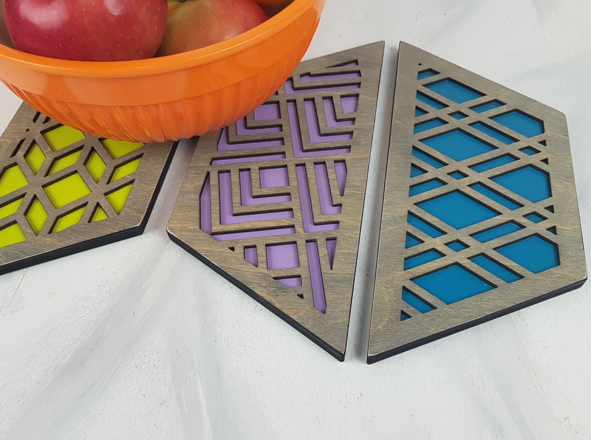 A group shot of the colorful geometric hexagon trivets arranged together.